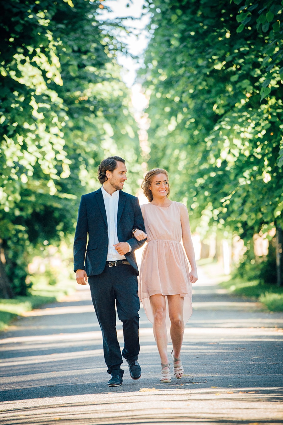 Couple photographed in avenue with trees. Pre wedding beloved session.